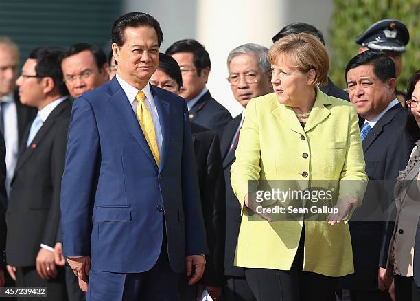 German Chancellor Angela Merkel accompanies Vietnamese Prime Minister Nguyen Tan Dung upon his arrival for talks at the Chancellery on October 15,...