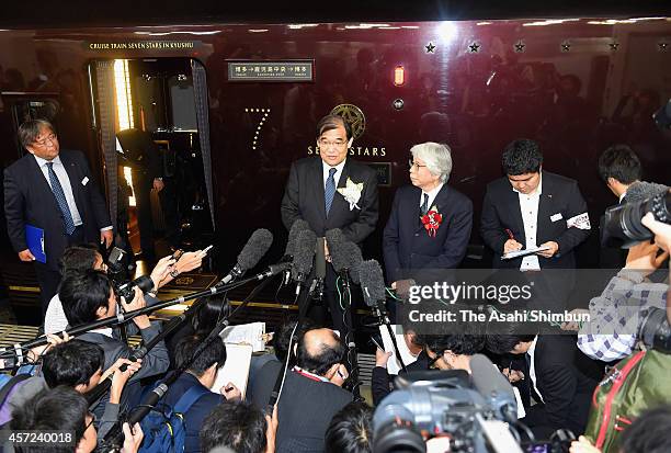 Kyushu's luxury sleeper cruise train 'Nanatsuboshi' departs while staffs wave during the first anniversary ceremony of its launch at Hakata Station...