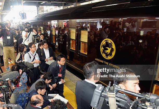 Kyushu's luxury sleeper cruise train 'Nanatsuboshi' departs while staffs wave during the first anniversary ceremony of its launch at Hakata Station...