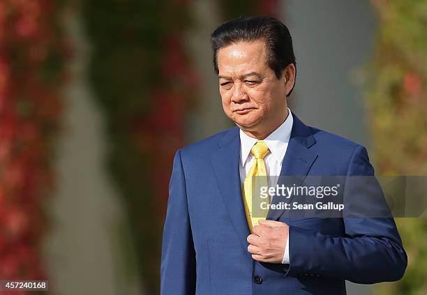 Vietnamese Prime Minister Nguyen Tan Dung arrives for talks with German Chancellor Angela Merkel at the Chancellery on October 15, 2014 in Berlin,...