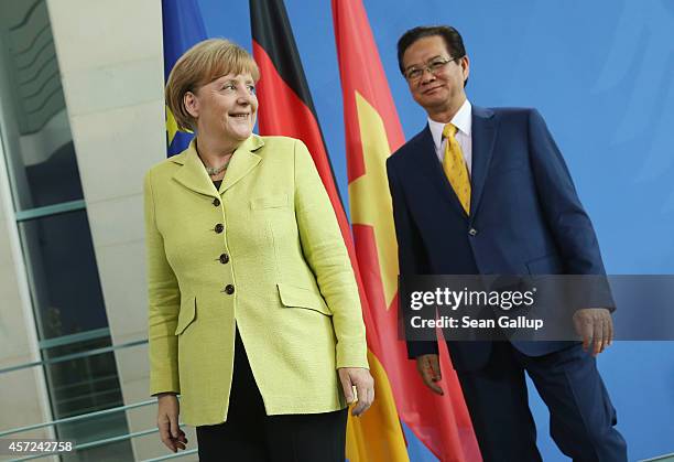 German Chancellor Angela Merkel and Vietnamese Prime Minister Nguyen Tan Dung depart after speaking to the media following talks at the Chancellery...