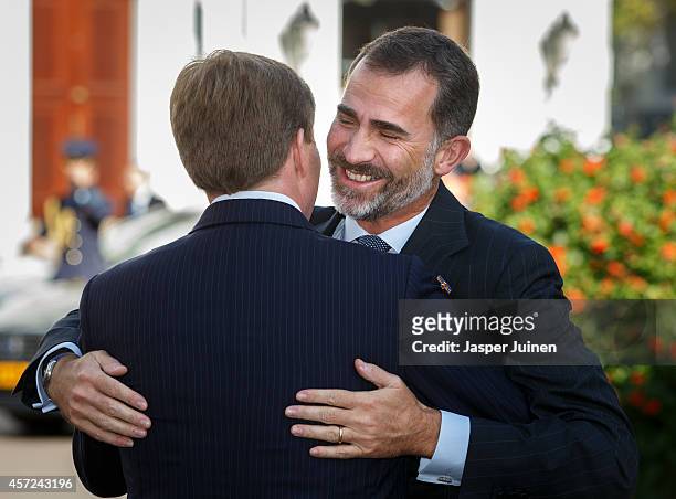King Felipe VI of Spain is welcomed by King Willem-Alexander of the Netherlands upon his arrival to Noordeinde palace on October 15, 2014 in The...