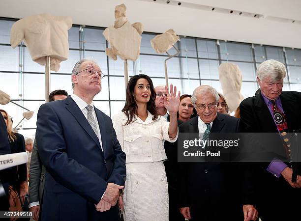 Amal Alamuddin Clooney gestures as she stands between the president of the Acropolis museum Dimitris Pantermalis , the minister of Culture and Sports...