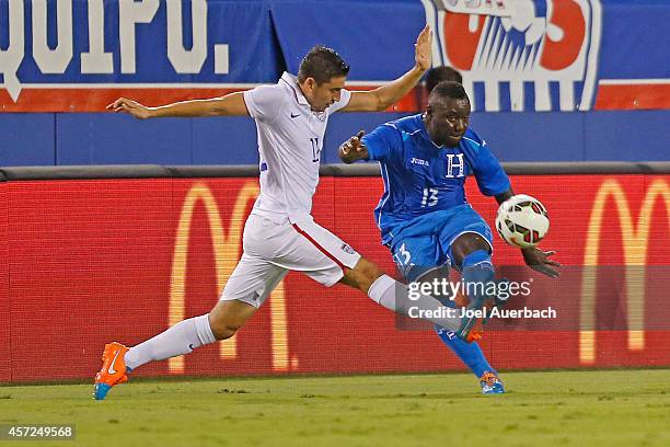 Alejandro Bedoya of the USA defends against Wilmer Crisanto of Honduras as he passes the ball during an International Friendly match on October 14,...