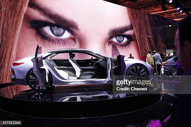 Visitors look at an Infinity Q80 inspiration automobile during the Paris Motor Show on October 14, 2014 in Paris, France. More than a million...