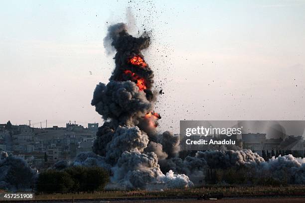 Photograph taken from Suruc district of Sanliurfa, Turkey, shows smoke rising from the Syrian border town of Kobani following the US-led coalition...