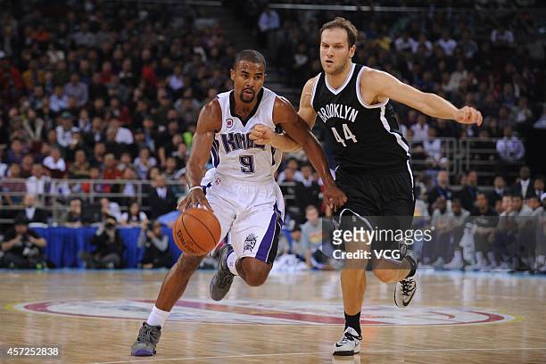 Ramon Sessions of the Sacramento Kings drives against Bojan Bogdanovic of the Brooklyn Nets during the game between the Brooklyn Nets and the...