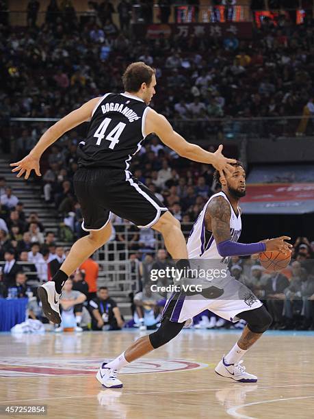 Bojan Bogdanovic of the Brooklyn Nets defends against Derrick Williams of the Sacramento Kings during the game between the Brooklyn Nets and the...