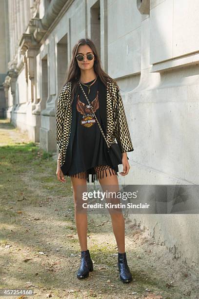 Model Gizele Oliveira is wearing Rayban sunglasses, Harley Davidson t-shirt, vintage jacket and bag and Kurt Geiger shoes on day 8 of Paris...