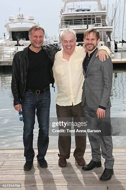 Michael Nyqvist, Robert Moresco and Dominic Monaghan pose during the '100 Code' photocall at Mipcom 2014 on October 13, 2014 in Cannes, France.