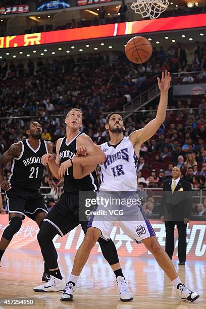 Omri Casspi of the Sacramento Kings and Mason Plumlee of the Brooklyn Nets battle for a rebound during the game between the Brooklyn Nets and the...