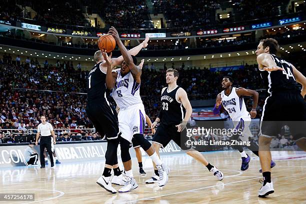 Rudy Gay of Sacramento Kings shoots against Mason Plumlee of Brooklyn Nets during the 2014 NBA Global Games match between the Brooklyn Nets and...