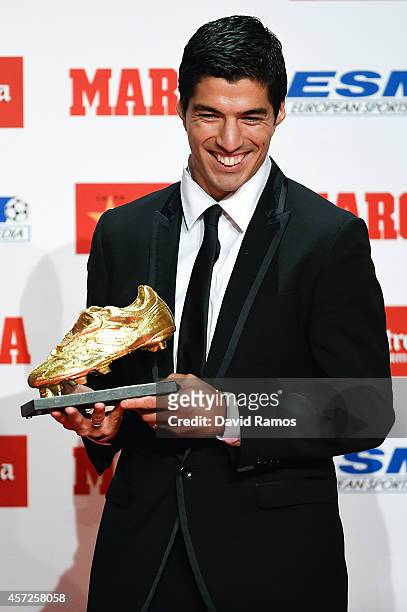 Luis Suarez of FC Barcelona poses with the Golden Boot Trophy as the best goal scorer in all European Leagues last season on October 15, 2014 in...
