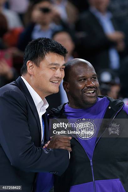 Yao Ming former NBA basketball star talk with Shaquille O'Neal during the 2014 NBA Global Games match between the Brooklyn Nets and Sacramento Kings...