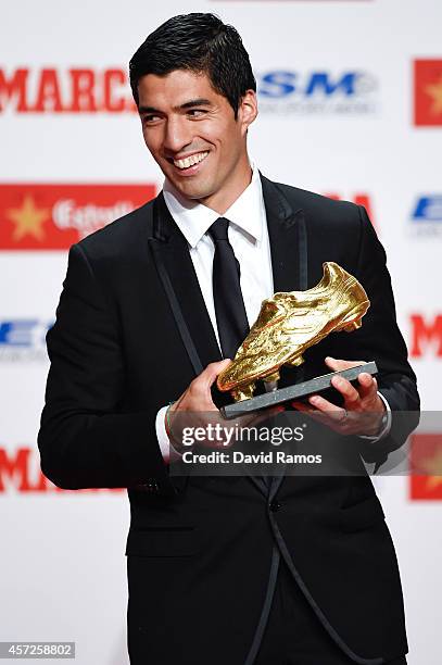 Luis Suarez of FC Barcelona poses with the Golden Boot Trophy as the best goalscorer in all European Leagues last season on October 15, 2014 in...