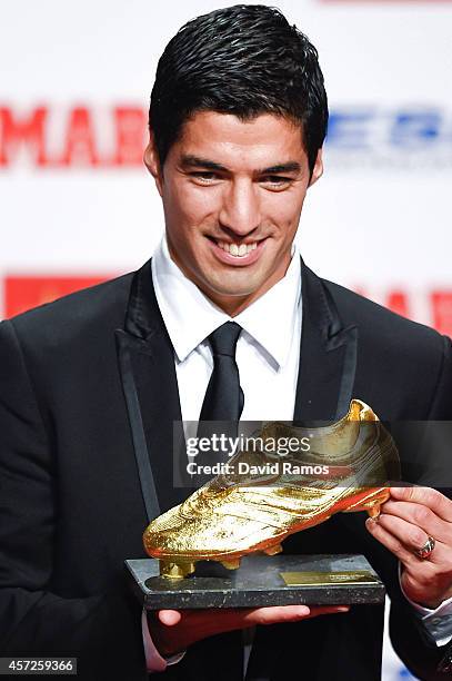 Luis Suarez of FC Barcelona poses with the Golden Boot Trophy as the best goal scorer in all European Leagues last season on October 15, 2014 in...