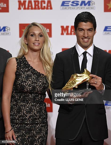Barcelona's Uruguayan forward Luis Suarez poses with his wife Sofia Balbi after receiving the 2014 Golden Boot, awarded to the European football...