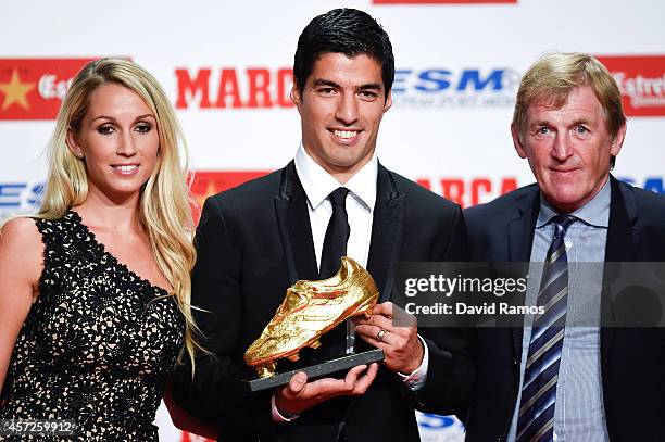 Luis Suarez poses with the Goden Boot Trophy as the best goal scorer in all European Leagues last season with his wife Sofia Balbi and Kenny Dalglish...