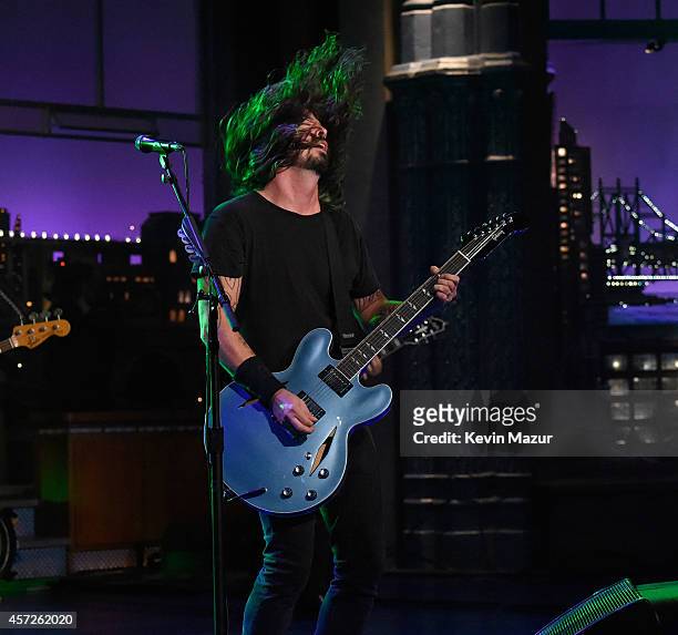 Dave Grohl of Foo Fighters performs onstage after the premiere of Foo Fighters "Sonic Highways" at the Ed Sullivan Theater on October 14, 2014 in New...