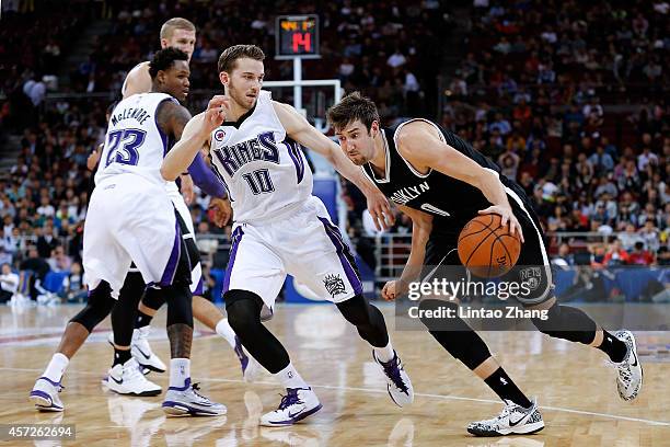 Sergey Karasev of Brooklyn Nets drives to the basket against Nik Stauskas of Sacramento Kings during the 2014 NBA Global Games match between the...