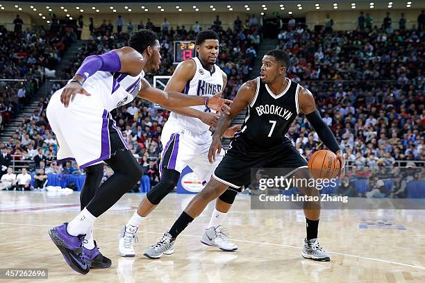 Joe Johnson of Brooklyn Nets drives to the basket against Rudy Gay and Ben Mclemore of Sacramento Kings during the 2014 NBA Global Games match...