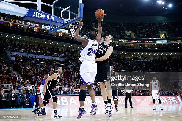 Carl Landry of Sacramento Kings shoots against Mirza Teletovic of Brooklyn Nets during the 2014 NBA Global Games match between the Brooklyn Nets and...