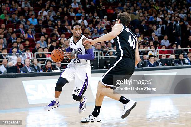 Ben Mclemore of Sacramento Kings drives against Bojan Bogdanovic of Brooklyn Nets during the 2014 NBA Global Games match between the Brooklyn Nets...