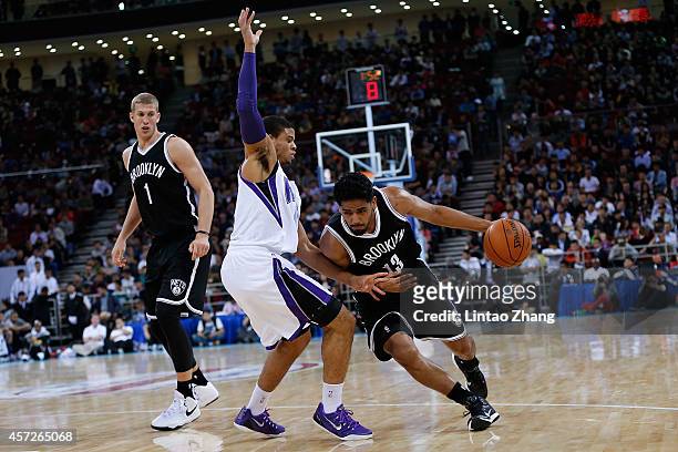 Jorge Gutierrez of Brooklyn Nets drives to the basket against Ray McCallum of Sacramento Kings during the 2014 NBA Global Games match between the...