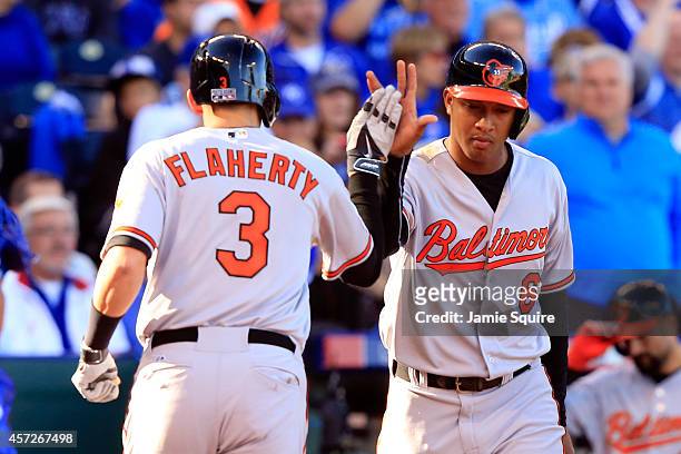 Ryan Flaherty of the Baltimore Orioles celebrates with Jonathan Schoop after hitting a solo home run to right field against Jason Vargas of the...