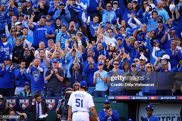 Fans cheer as Jason Vargas of the Kansas City Royals walks back to the dugout after being relieved in the sixth inning against the Baltimore Orioles...