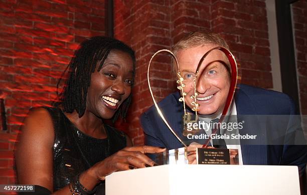 Auma Obama, founder 'Sauti Kuu' and Christian Courtin - Clarins, CEO Clarins attend the Prix Courage Award 2014 on October 15, 2014 at...