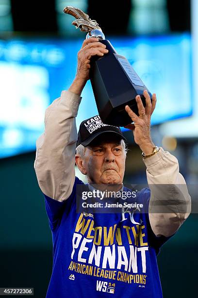 David Glass, Owner and Chief Executive Officer of the Kansas City Royals, hoist the William Harridge Award after their 2 to 1 win over the Baltimore...