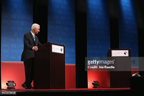 Former Florida Governor and Democratic candidate for Governor Charlie Crist waits next to an empty podium for Republican Florida Governor Rick Scott...