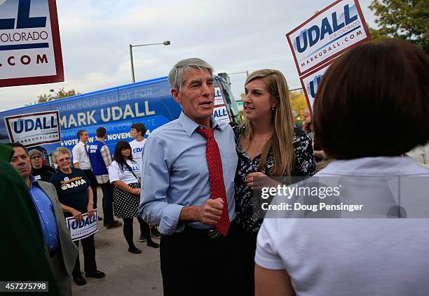 Tess Udall looks on as her father, U.S. Sen. Mark Udall , speaks to supporters as he kicks off his 'Mark Your Ballot' bus tour on October 15, 2014 in...