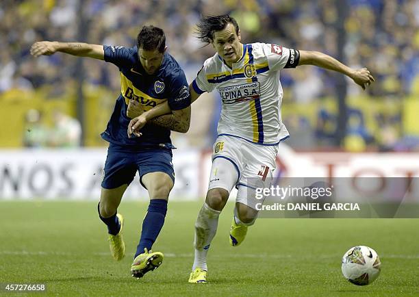 Argentina's Boca Juniors forward Juan Martinez vies for the ball with Paraguay's Deportivo Capiata defender Arturo Aquino during their Copa...