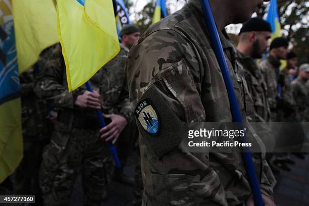 Supporters of Ukrainian Nationalist Party hold torches and flags, as they march in Kiev downtown during the 72nd anniversary of the Ukrainian...