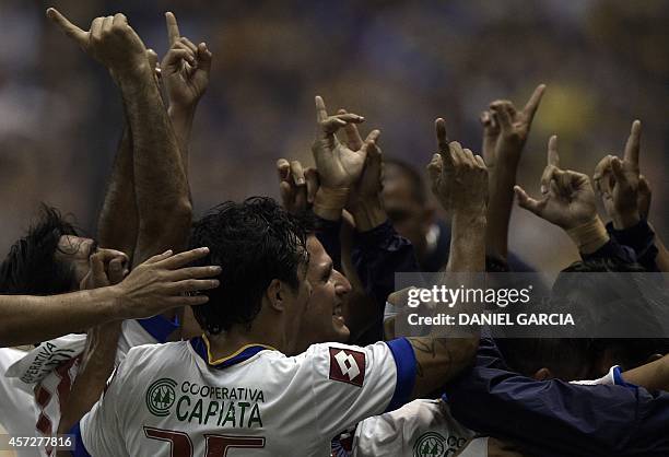 Paraguay's Deportivo Capiata players celebrate after scoring a goal against Argentina's Boca Juniors during the Copa Sudamericana 2014 football match...