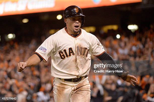 Juan Perez of the San Francisco Giants celebrates after scoring in the sixth inning against the St. Louis Cardinals during Game Four of the National...