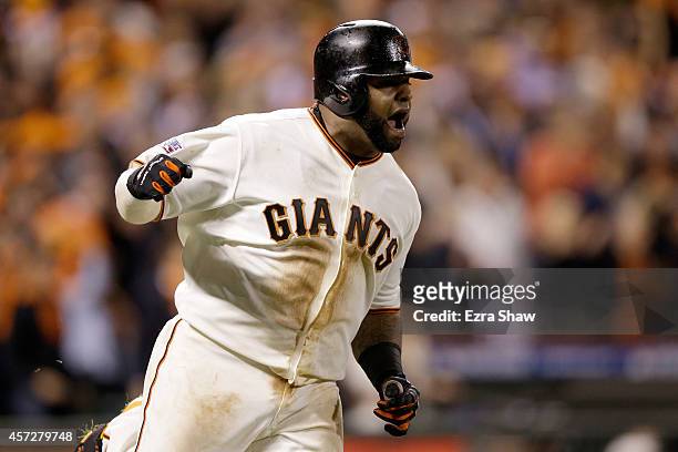 Pablo Sandoval of the San Francisco Giants reacts after hitting a single in the sixth inning against the St. Louis Cardinals during Game Four of the...