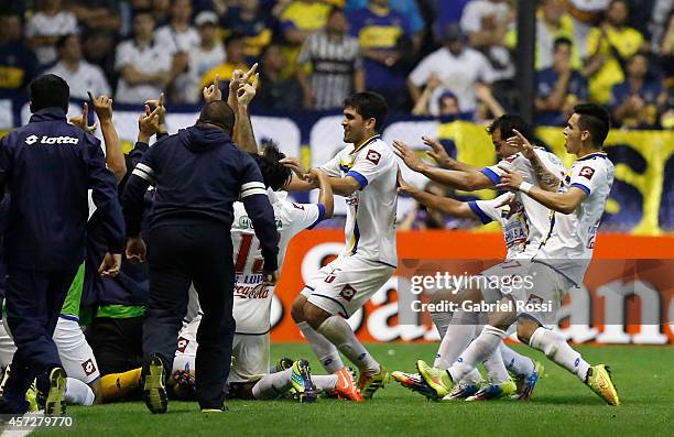 Players of Deportivo Capiata celebrate an own goal scored by Lisandro Magallán of Boca Juniors during a match between Boca Juniors and Deportivo...