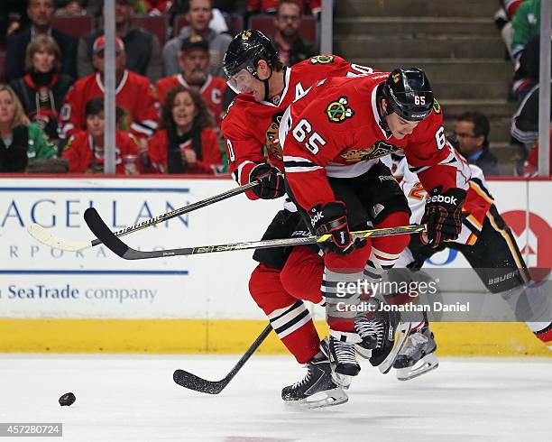 Andrew Shaw and Patrick Sharp of the Chicago Blackhawks collide during a game against the Calgary Flames at the United Center on October 15, 2014 in...