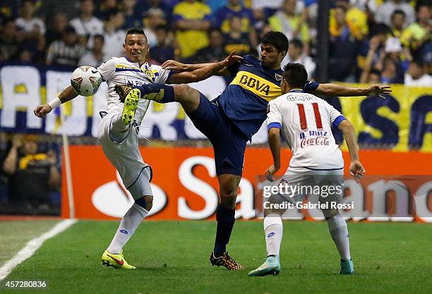 Leandro Marin of Boca Juniors fights for the ball with Fabio Escobar of Deportivo Capiata during a match between Boca Juniors and Deportivo Capiata...