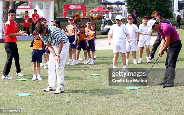 Robert Jan Derksen of The Netherlands and Liang Wen-Chong of China take part in a kids golf clinic during the first round of the 2014 Hong Kong open...