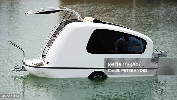 Sealander" swimming caravan swims on the Stoermthaler See lake in Grosspoesna, eastern Germany, on October 15 during an event to promote the...