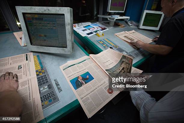 Employees inspect the print quality on copies of Vedomosti, a daily business newspaper owned by the Financial Times, the Wall Street Journal and...