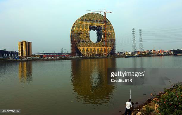 This picture taken on October 30, 2013 shows the Circle building under construction in Guangzhou, southern China's Guangdong province. China's...