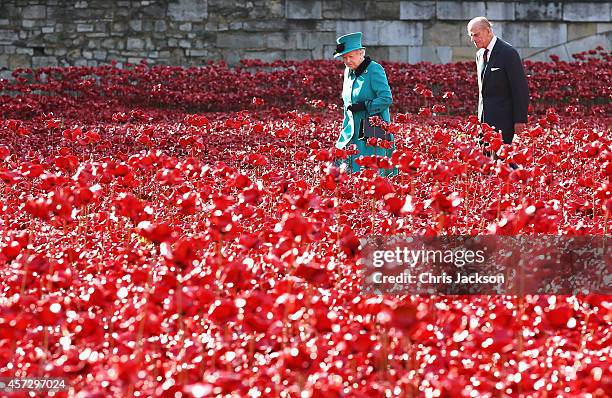 Queen Elizabeth II and Prince Philip, Duke of Edinburgh visit the Blood Swept Lands and Seas of Red evolving art installation at the Tower of London...