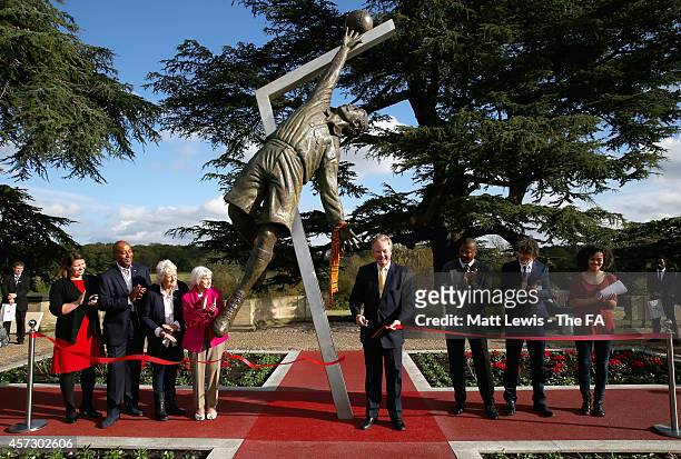 David Sheepshanks, Chairman of St George's Park cuts the ribbon to unveil the Arthur Wharton Statue, as Julie Harrington, Dave Regis, Vivien Mallock,...