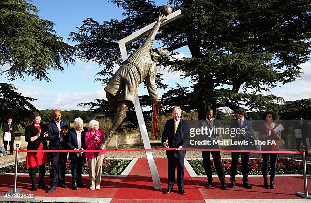 David Sheepshanks, Chairman of St George's Park cuts the ribbon to unveil the Arthur Wharton Statue, as Julie Harrington, Dave Regis, Vivien Mallock,...