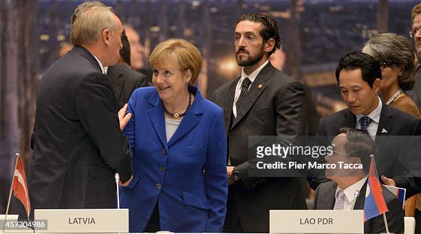 German Chancellor Angela Merkel speaks with Prime Minister of Latvia Andris Berzins during the 10 ASEM Summit with 50 Heads Of State From Europe And...